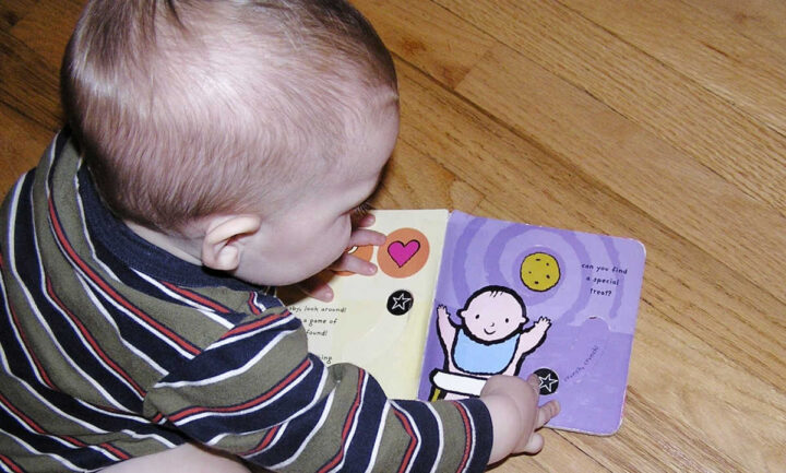 Baby playing with board book