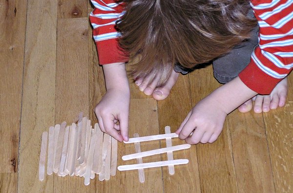 Child Building with crafts sticks